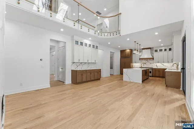 a large white kitchen with a large window
