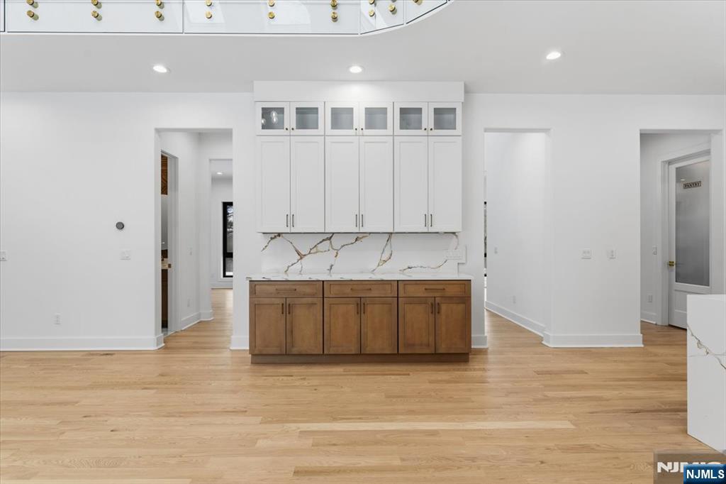 83 Falcon Road Livingston, NJ 07039 - Photo 22 of 34 a large white kitchen with granite countertop white cabinets and stainless steel appliances