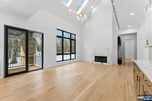 a view of an empty room with a fireplace and a window
