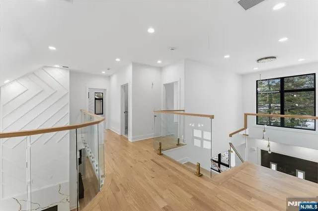 a view of a living room a dining room wooden floor and a window