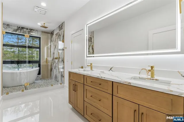 a bathroom with a granite countertop sink mirror and vanity