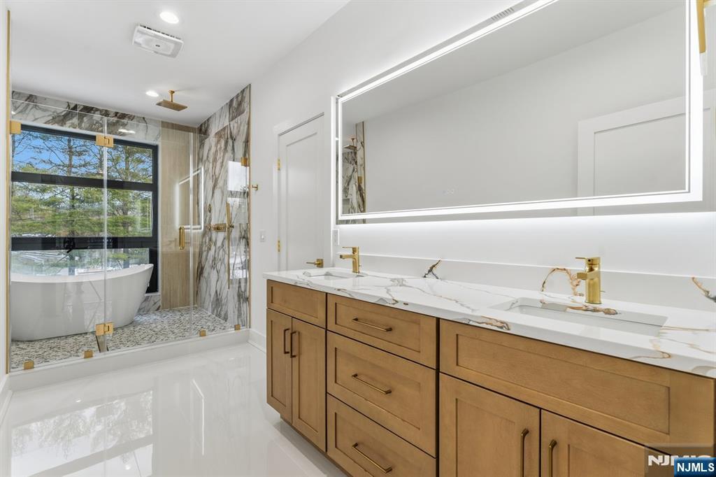 83 Falcon Road Livingston, NJ 07039 - Photo 7 of 34 a bathroom with a granite countertop sink mirror and vanity