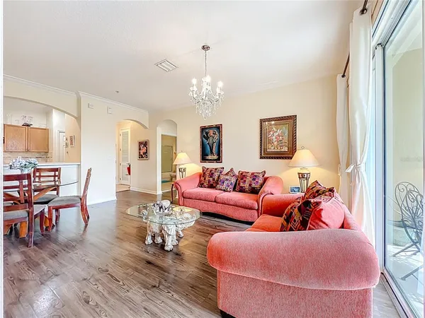 a living room with furniture dining table and wooden floor
