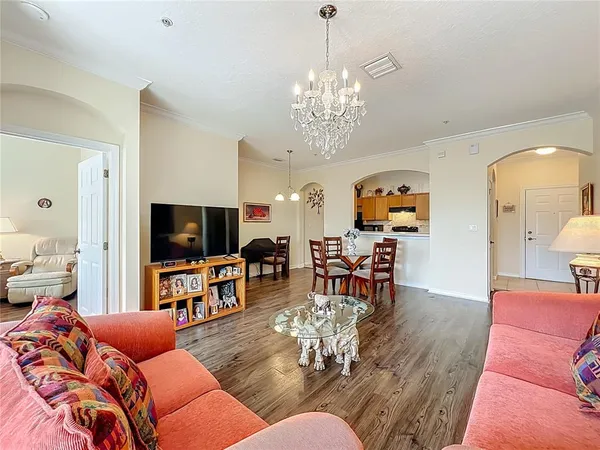 a living room with furniture flat screen tv and couches