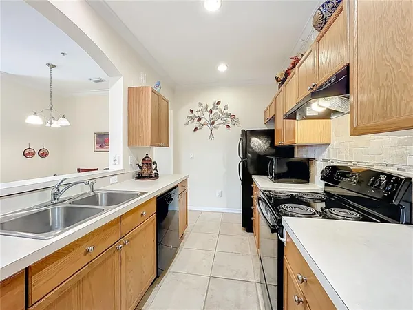a kitchen with a sink stove and cabinets
