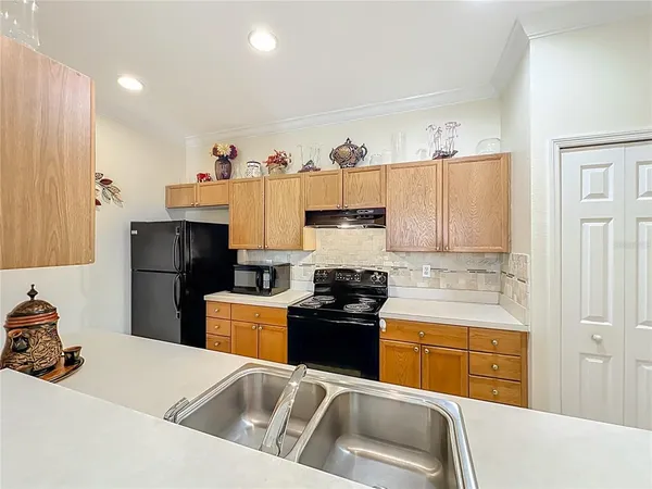 a kitchen with a sink a stove and refrigerator