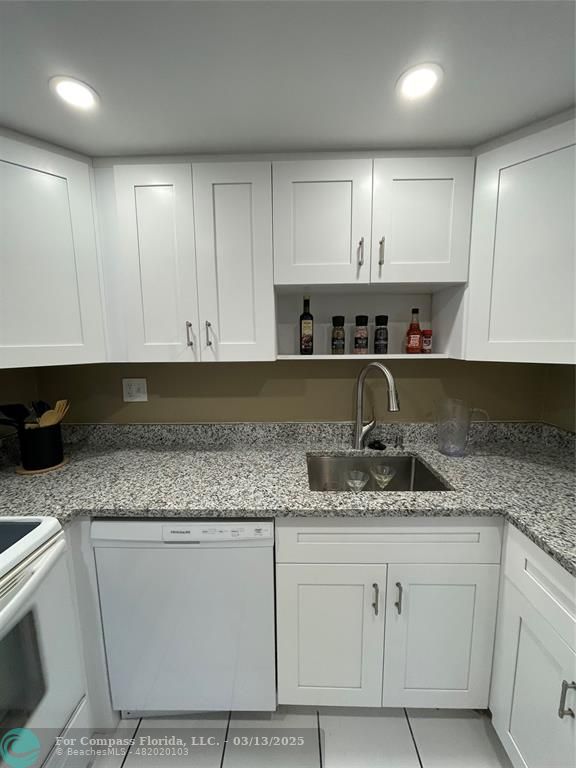 1400 Northeast 54th Street, Unit 203 Fort Lauderdale, FL 33334 - Photo 16 of 19 a kitchen with granite countertop a sink and cabinets