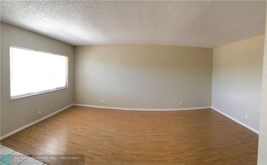 1400 Northeast 54th Street, Unit 203 Fort Lauderdale, FL 33334 - Photo 3 of 19 a view of an empty room with a window