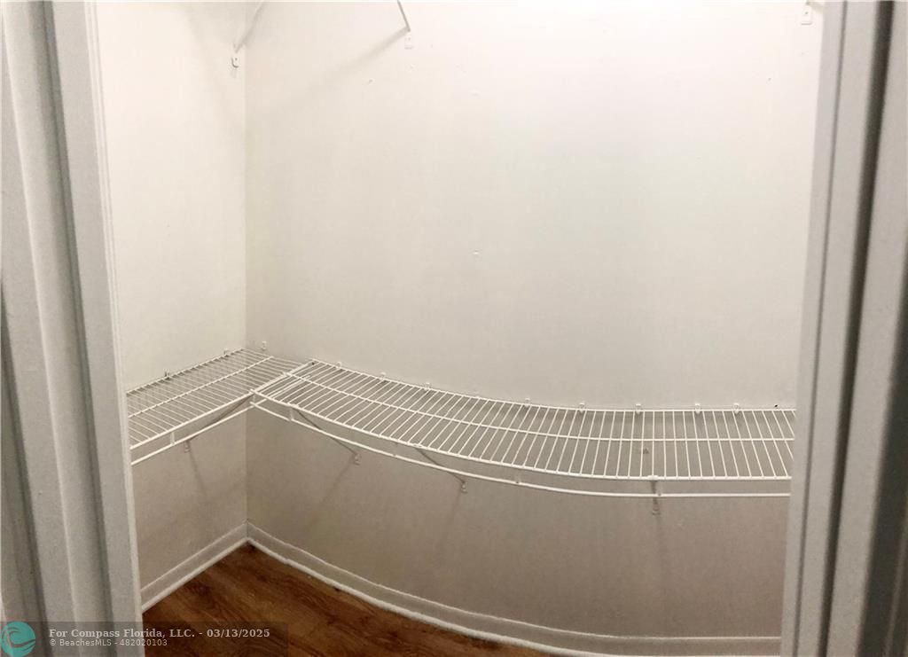 1400 Northeast 54th Street, Unit 203 Fort Lauderdale, FL 33334 - Photo 7 of 19 a view of a room with racks on the wall