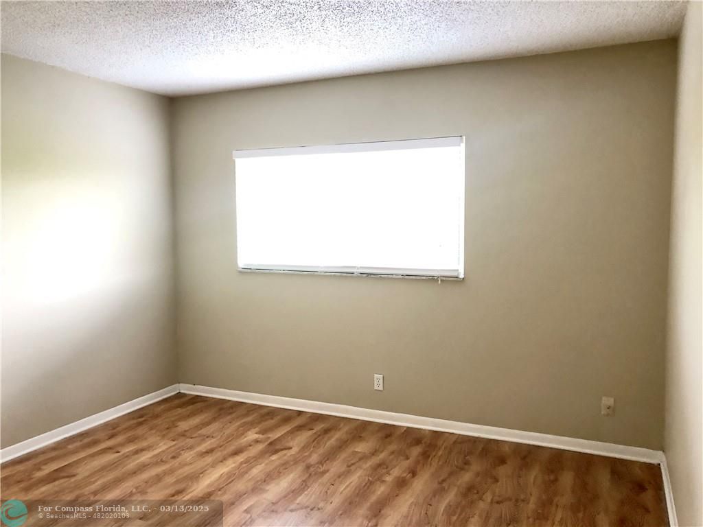 1400 Northeast 54th Street, Unit 203 Fort Lauderdale, FL 33334 - Photo 8 of 19 an empty room with a window