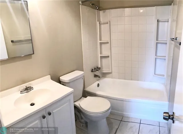 a bathroom with a sink a toilet and bathtub
