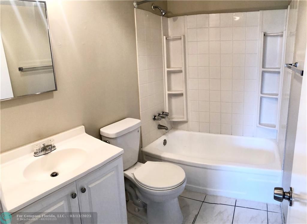 1400 Northeast 54th Street, Unit 203 Fort Lauderdale, FL 33334 - Photo 9 of 19 a bathroom with a sink a toilet and bathtub