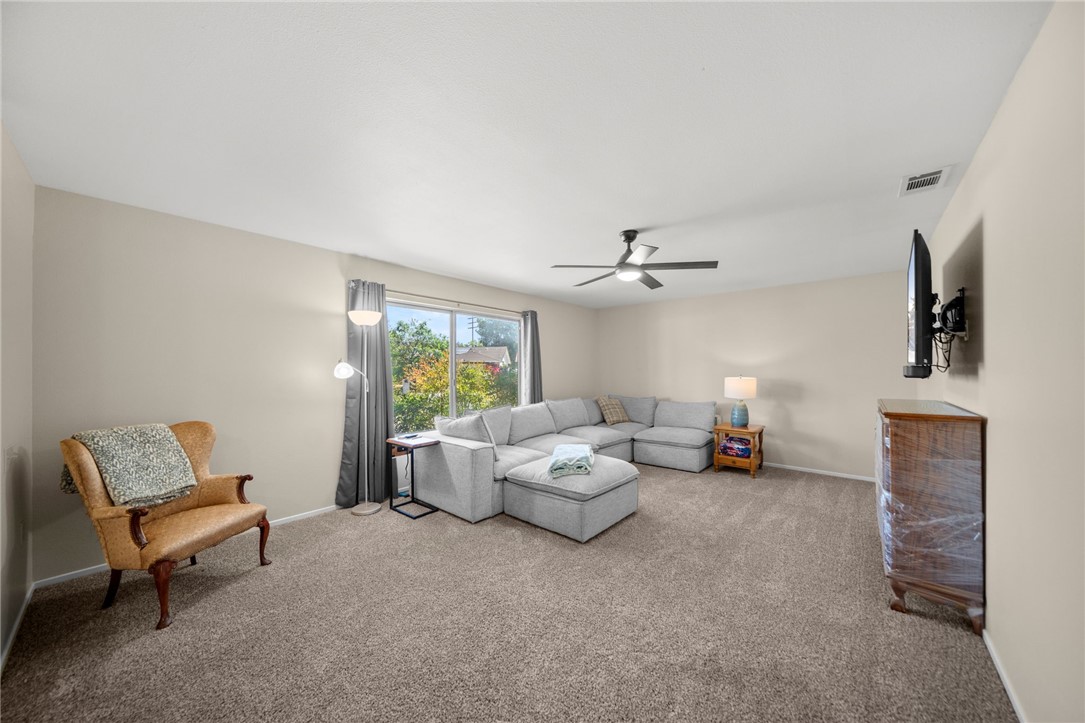 27879 Foxfire Street Menifee, CA 92586 - Photo 9 of 36 a living room with furniture and a chandelier