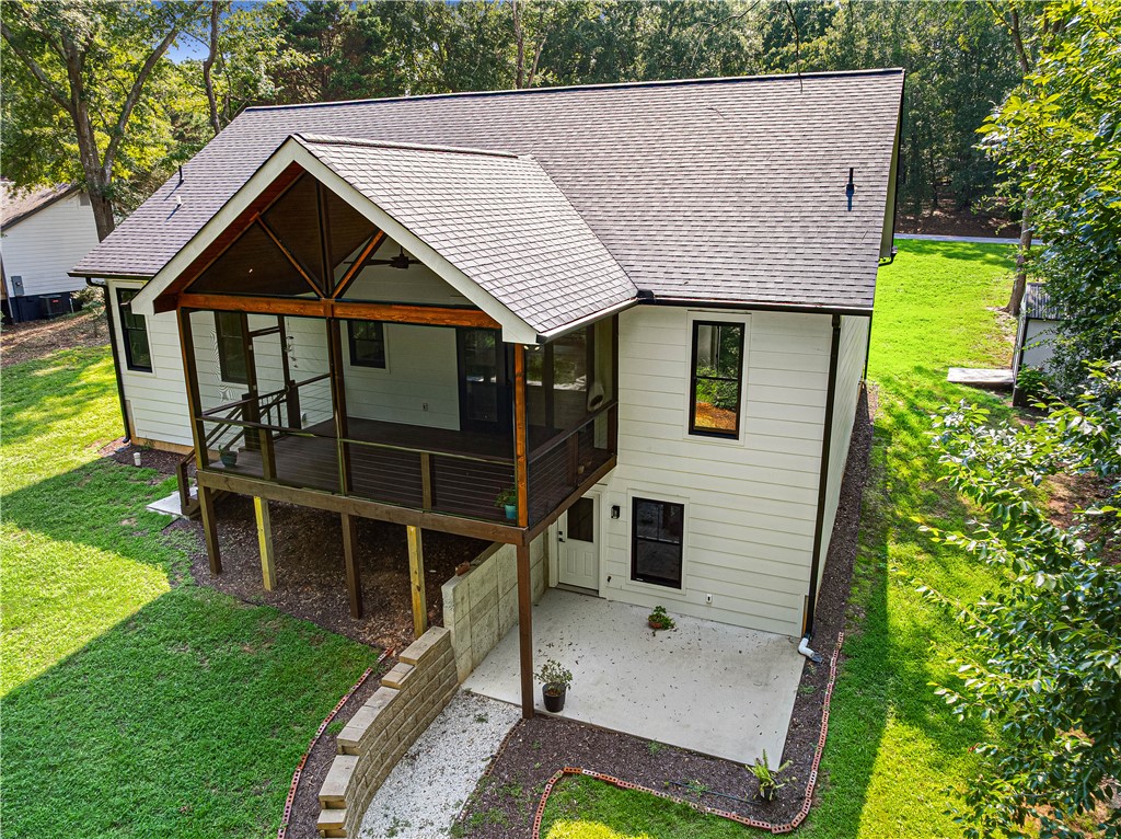 A elevated screened porch extends from this inviting home, offering abundant outdoor living space.