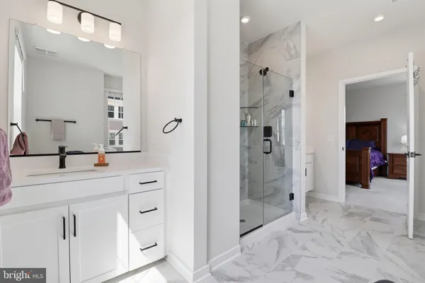 a bathroom with a shower sink and mirror