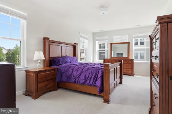 a bed room with a bed and a dresser