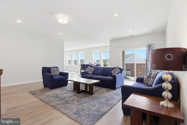 a living room with furniture rug and window