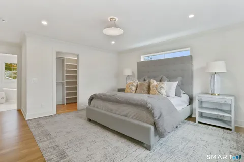 a bedroom with bed and a chandelier