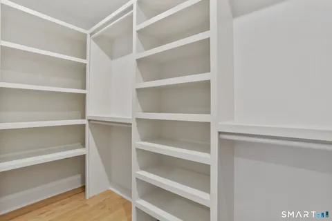 a view of walk in closet with empty racks