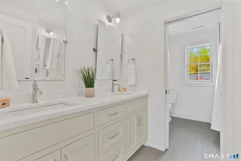 a bathroom with a double vanity sink and a mirror