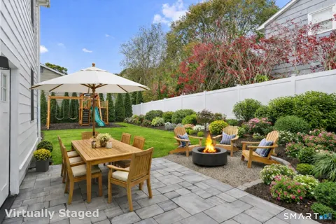 a view of a patio with table and chairs under an umbrella