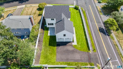 an aerial view of a house with a garden and a yard