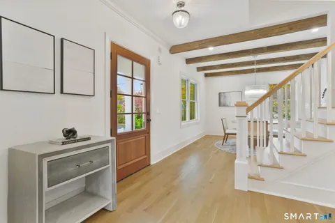 a view of entryway and hall with wooden floor