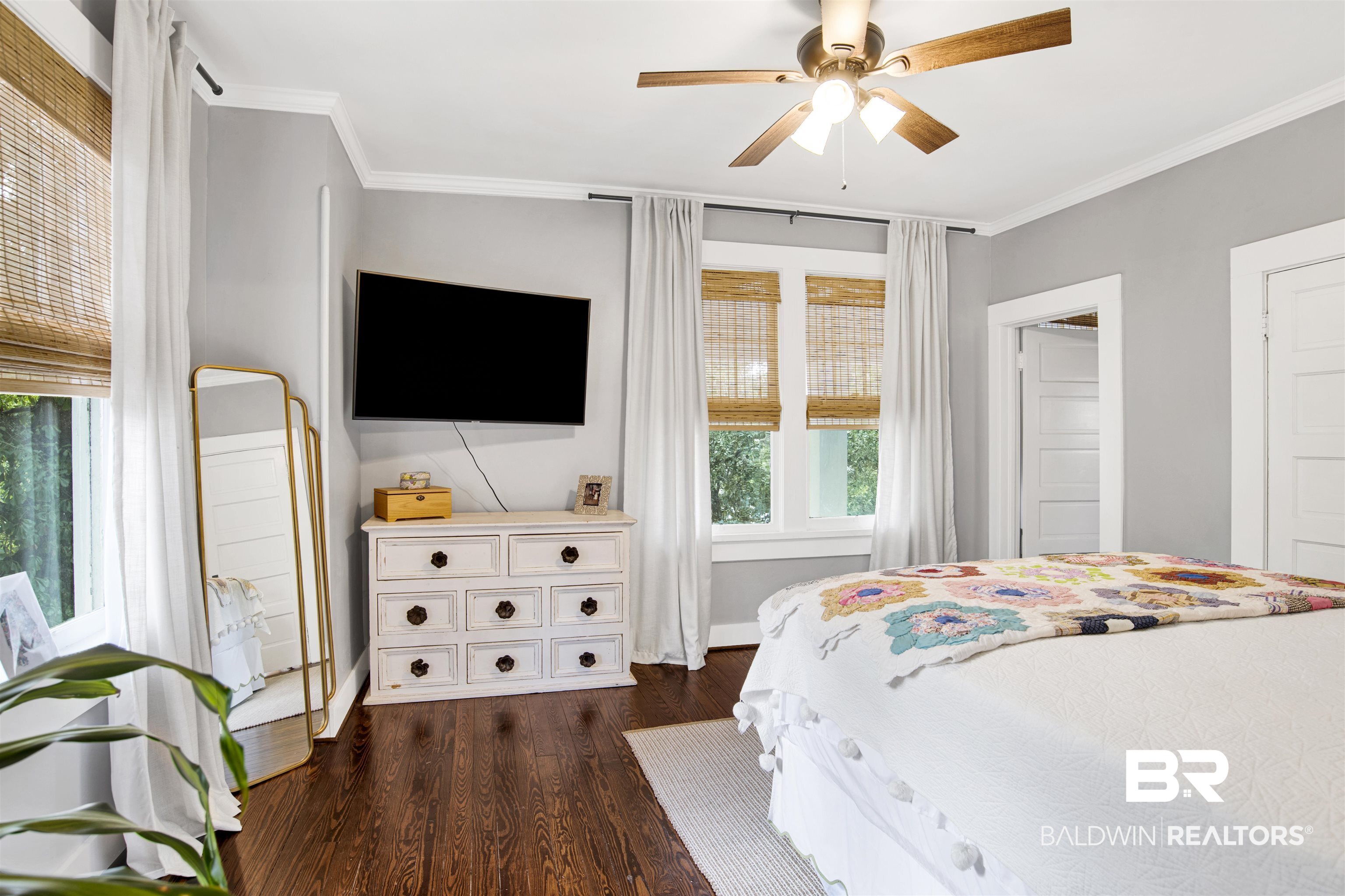 123 Macy Place Mobile, AL 36604 - Photo 30 of 35 Bedroom featuring dark wood-style floors, crown molding, and a ceiling fan