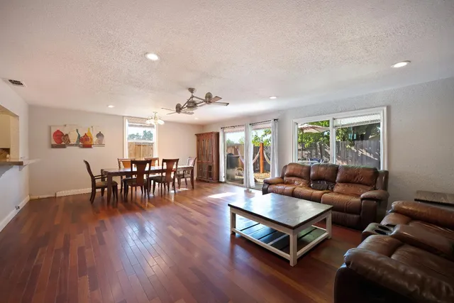 a view of a dining room with furniture and wooden floor