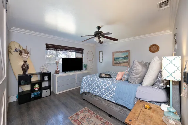 a bedroom with a large bed and a chandelier