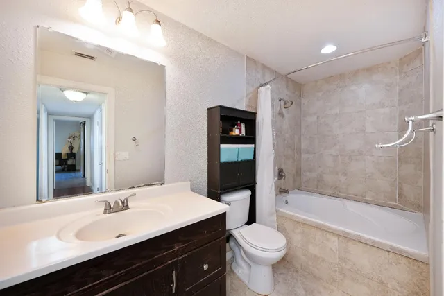 a view of a patio with table and chairs under an umbrella