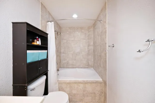 a view of a patio with table and chairs under an umbrella