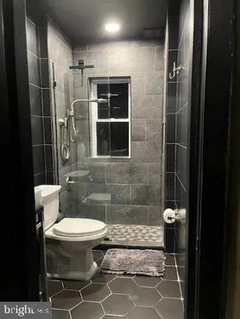 a bathroom with a toilet and a shower