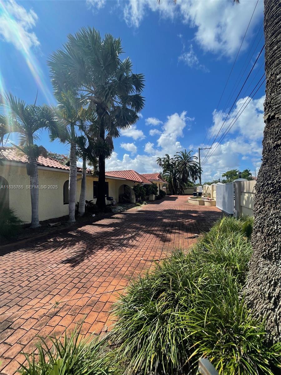 5550 Southwest 87th Avenue Miami, FL 33165 - Photo 5 of 6 a view of a street with some trees