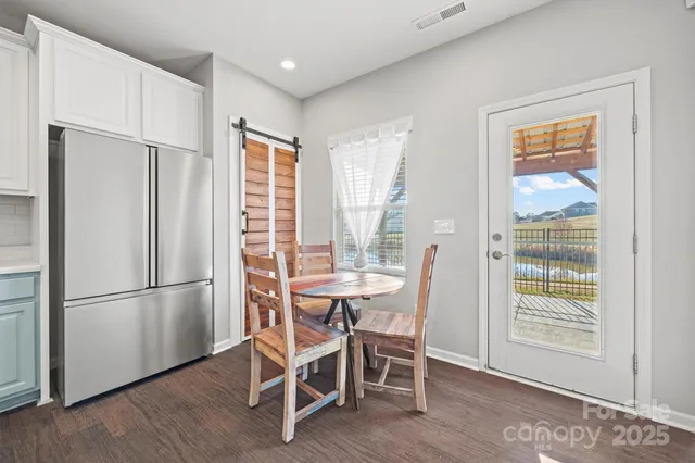 a dining room with furniture window front door and wooden floor