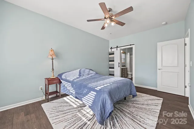 a bedroom with a large bed and a chandelier