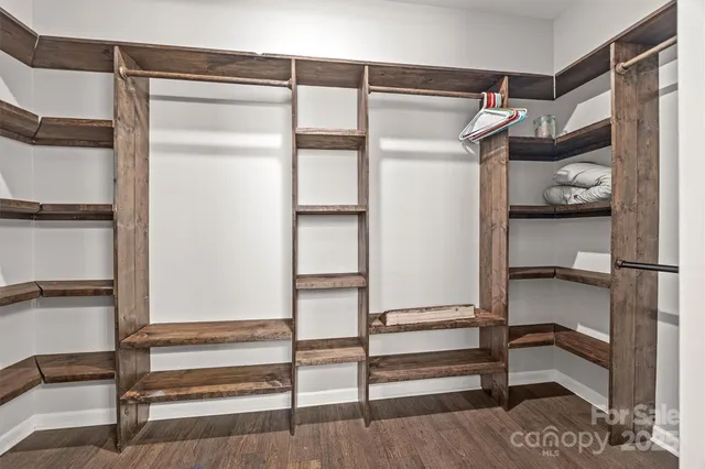 a view of walk in closet with empty racks