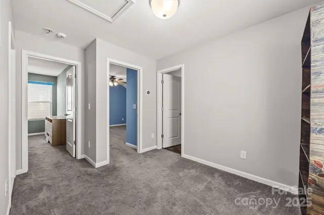 an empty room with closet and a bathroom