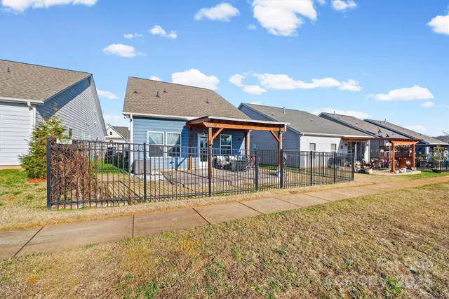 a swimming pool with outdoor seating and yard