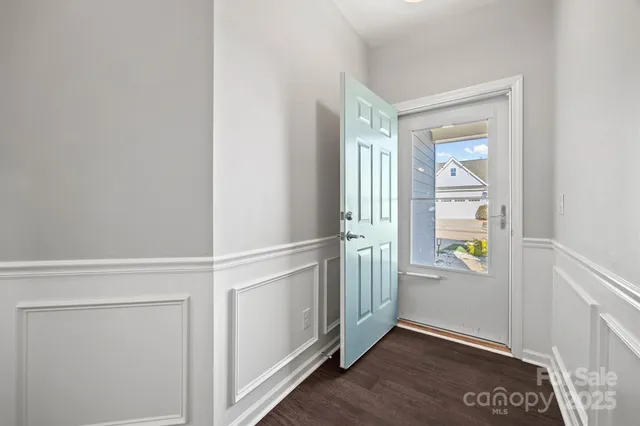 a view of an entryway with wooden floor