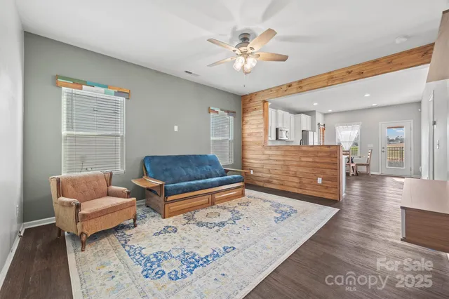 a living room with furniture and a chandelier