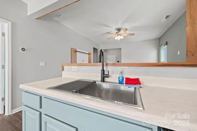 a bathroom with a sink and a chandelier