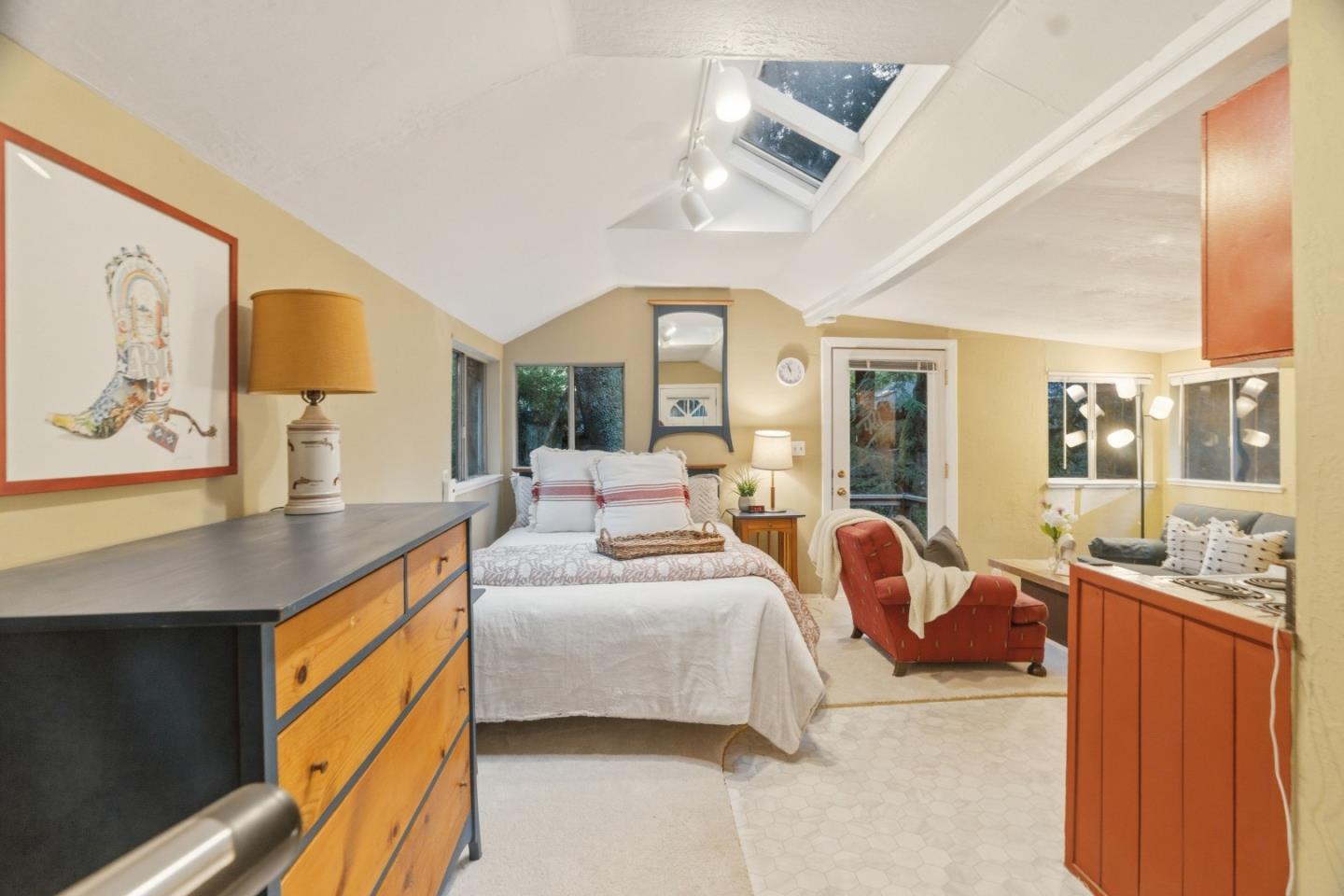 495 Primavera Road Boulder Creek, CA 95006 - Photo 12 of 36 a bedroom with furniture and large windows