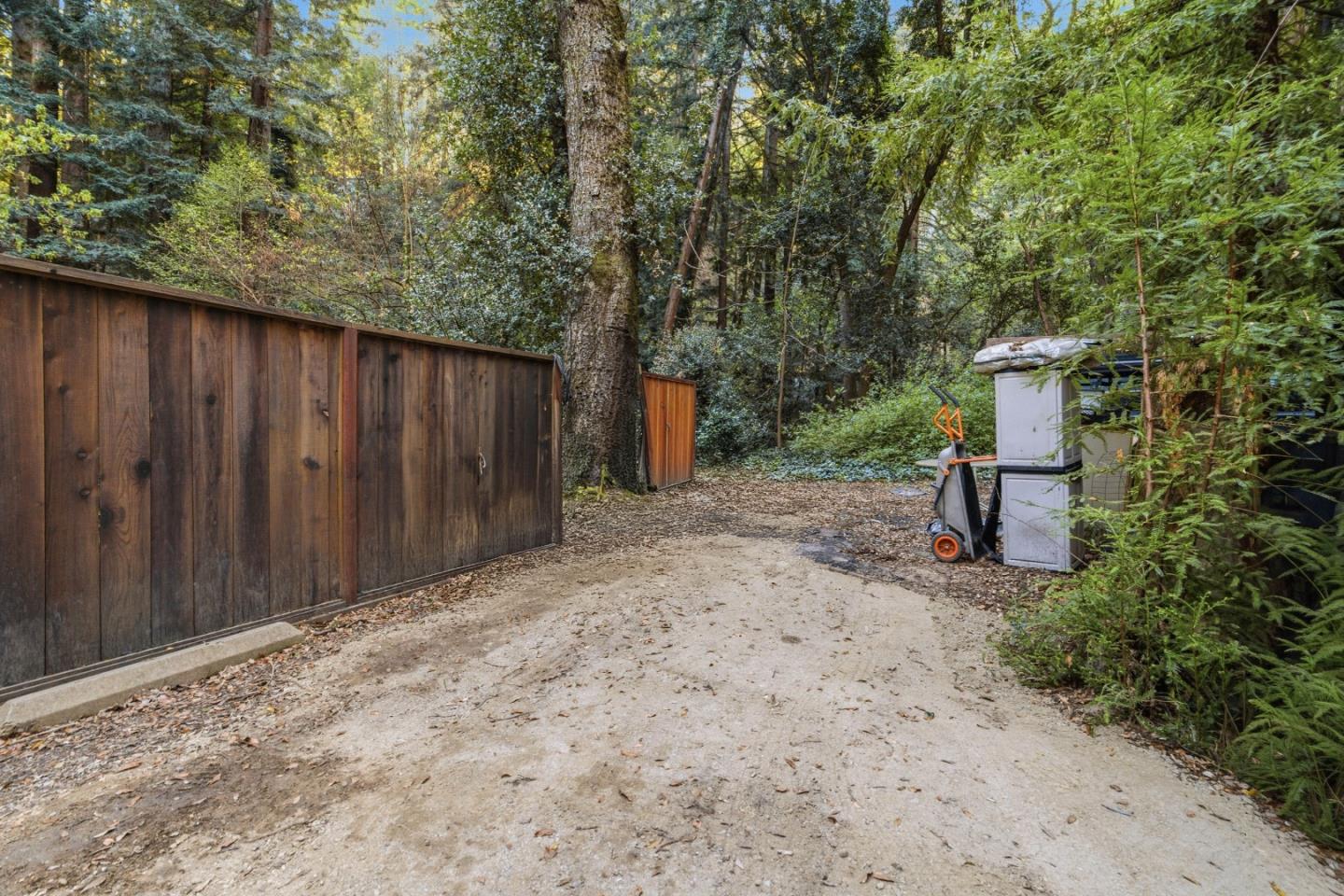 495 Primavera Road Boulder Creek, CA 95006 - Photo 15 of 36 a backyard of a house with two trees and stairs