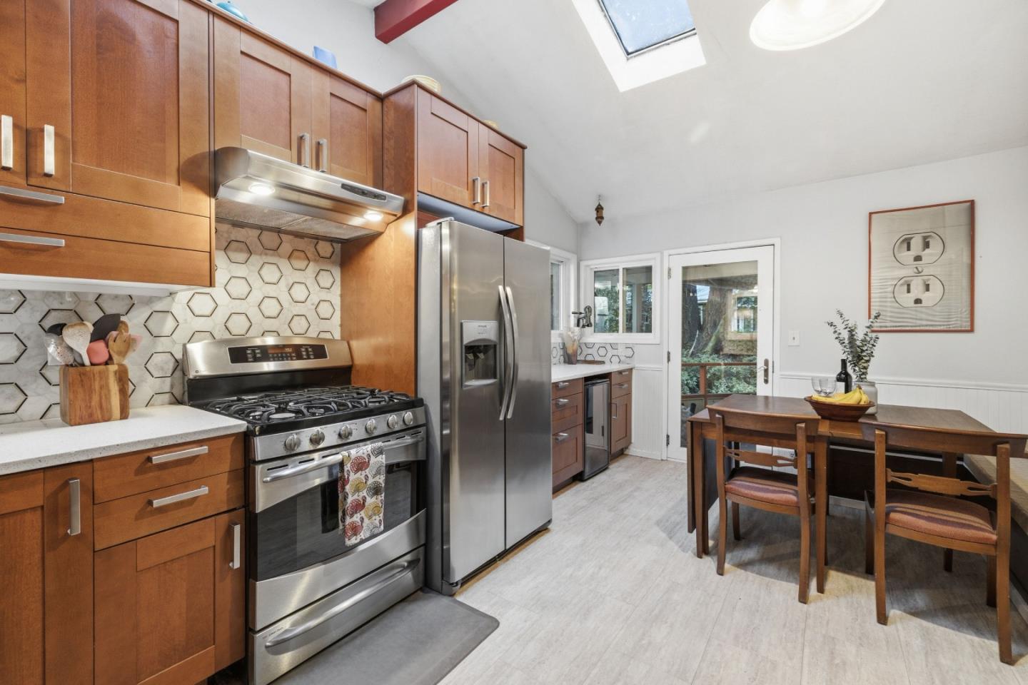 495 Primavera Road Boulder Creek, CA 95006 - Photo 3 of 36 a kitchen with stainless steel appliances a stove a refrigerator and a dining table