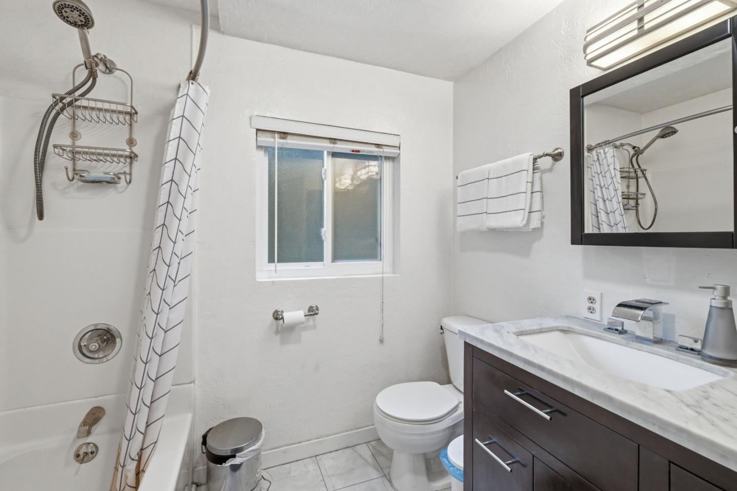 495 Primavera Road Boulder Creek, CA 95006 - Photo 4 of 36 a bathroom with a granite countertop sink a toilet and a mirror