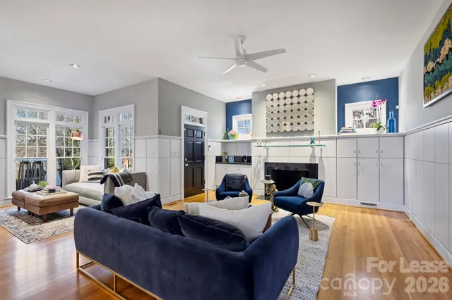 a living room with furniture fireplace and window