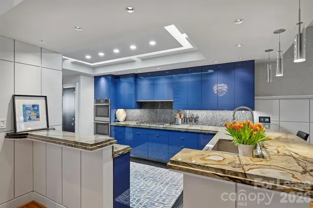 a kitchen with stainless steel appliances granite countertop sink stove and cabinets