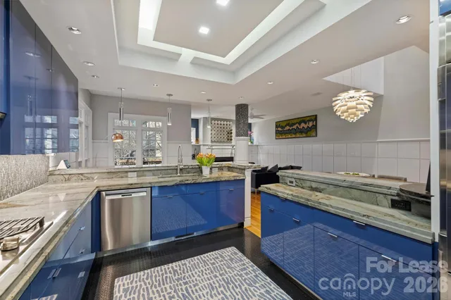 a kitchen with a stove a sink and cabinets