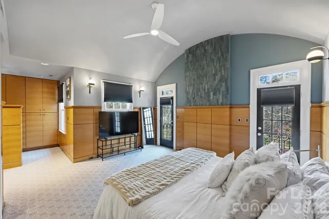 a bedroom with a bed and a television